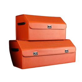Two orange storage boxes stacked on a white background, with one smaller box on top of a larger one. Both boxes have a textured finish, black handles, and silver metal clasps.