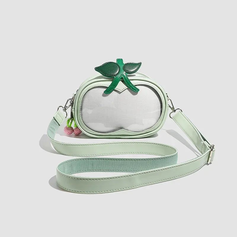 Apple-Shaped Crossbody Phone Purse – Lightweight Shoulder Bag A mint green faux-leather crossbody bag designed to look like an apple, featuring a clear front window, green leaf and stem details, and a matching mint green strap on a light gray background.