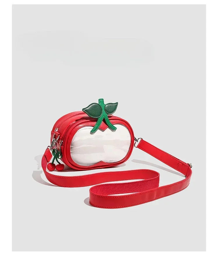 Apple-Shaped Crossbody Phone Purse – Lightweight Shoulder Bag A red apple-shaped crossbody bag with a clear front window, green leaf and stem detail on top, and a matching red shoulder strap, shown on a light gray background.