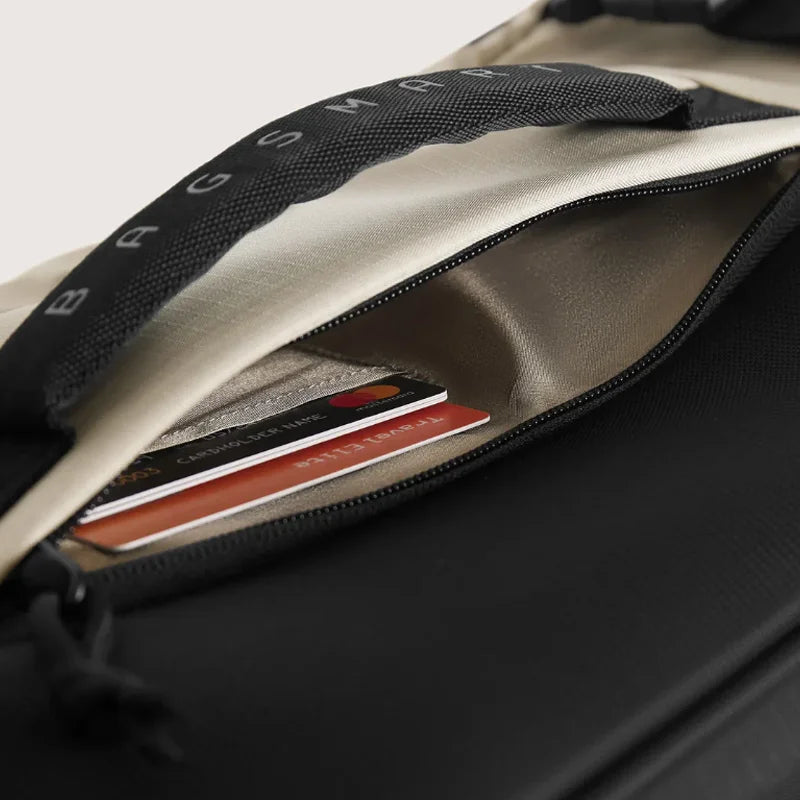 Wheeled Travel Backpack – Large Capacity Carry-On Close-up of a black bag with a compartment containing cards and a visible brand logo.