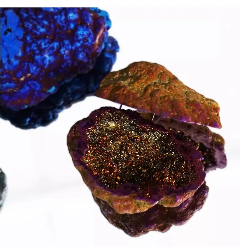 Luxury Portable Jewelry Box – Ring & Earring Travel Storage Case A close-up of a mineral specimen with a dark metallic glittery center and rough purple-brown outer edges, photographed on a white background. Another blue mineral piece is partially visible in the upper left.