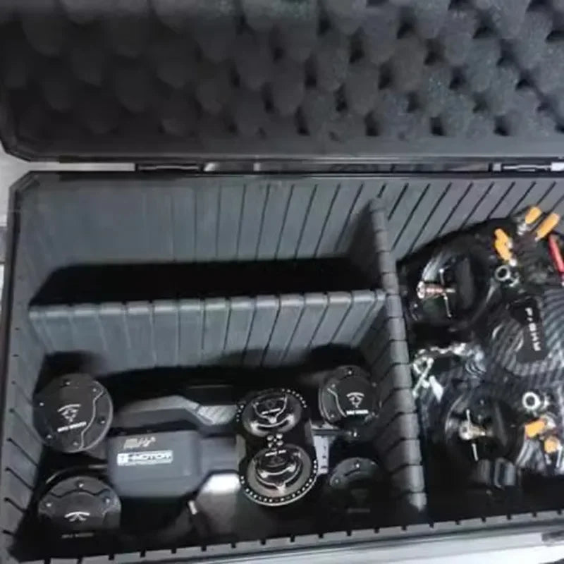 Aluminum Tool Storage Case – Large Waterproof Hard Organizer Box A black foam storage case opened to reveal organized compartments containing multiple black camera-related accessories and lenses.