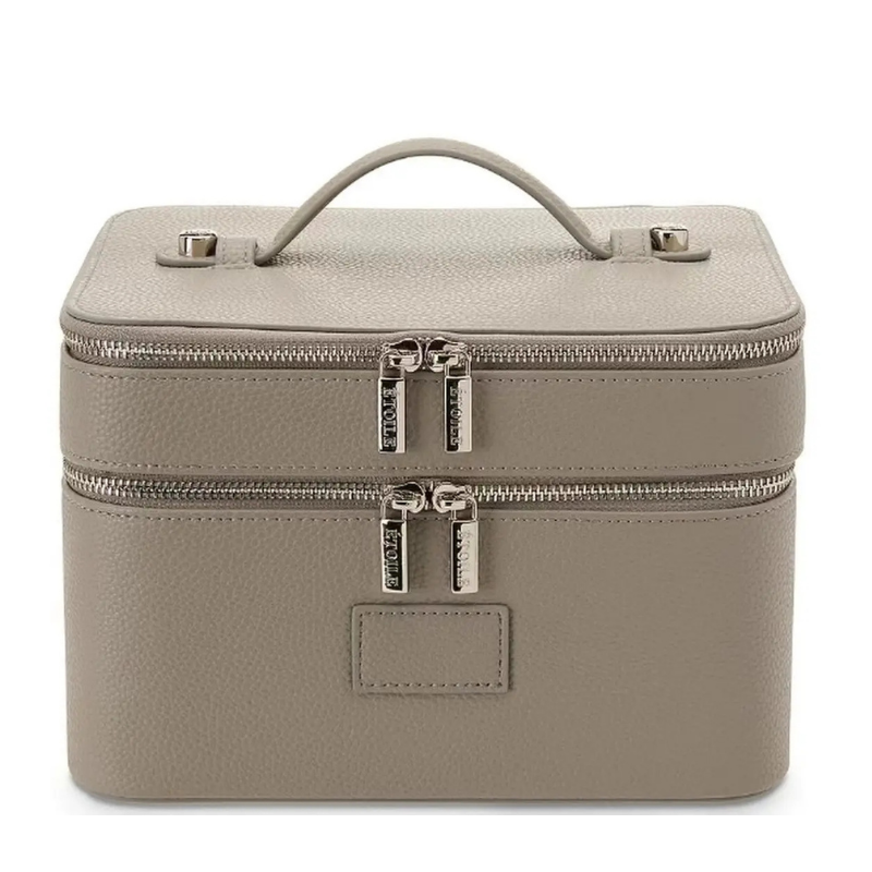 Travel Makeup Bag for Women – Large Double-Layer Cosmetic Organizer A structured rectangular makeup case in textured taupe leather with a top handle, two zip compartments, and silver-tone hardware, shown on a plain white background.