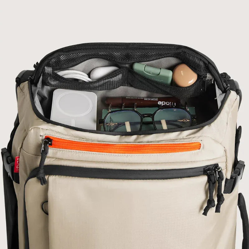 Wheeled Travel Backpack – Large Capacity Carry-On Beige backpack with open compartment showing various items on a light gray background