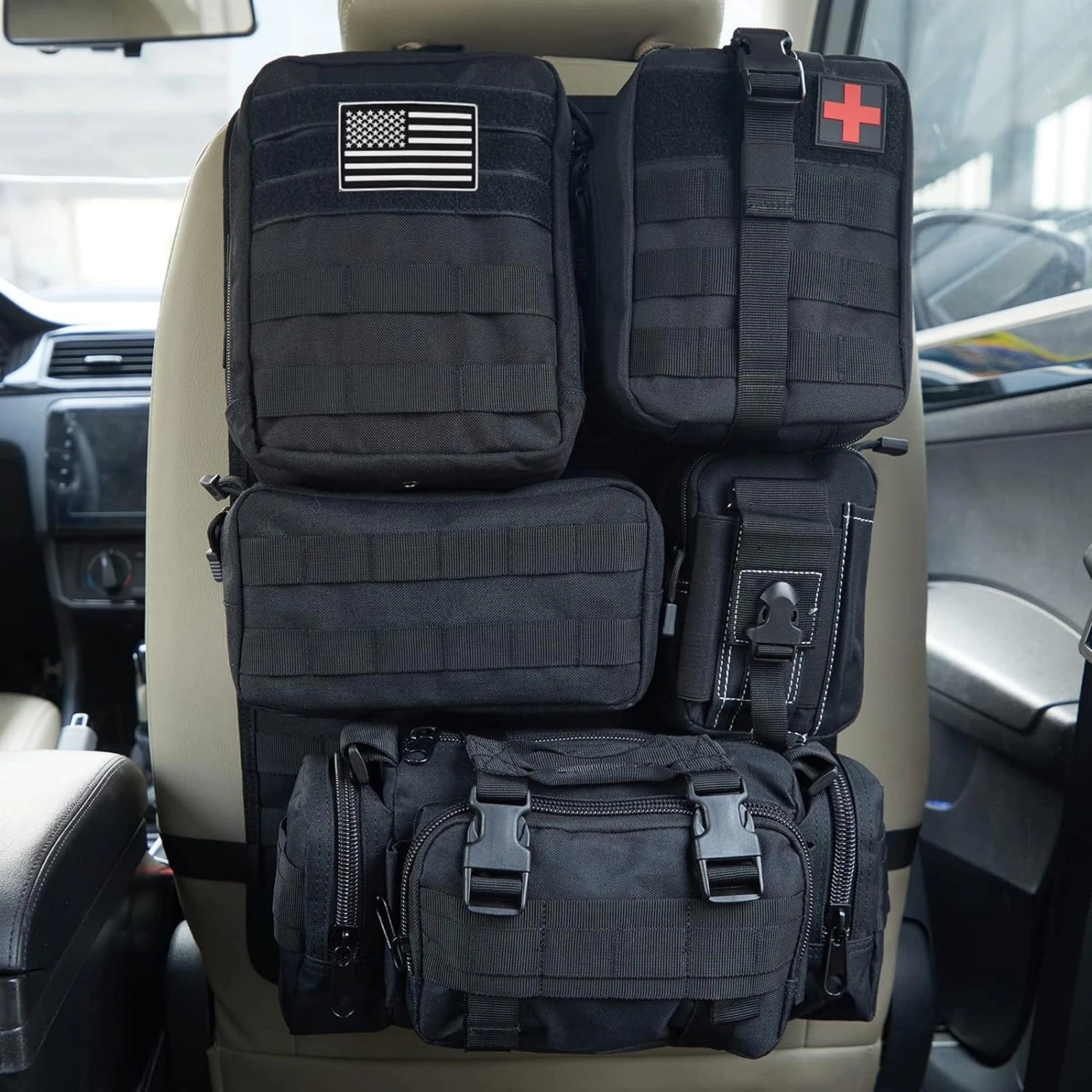 Car Backseat Organizer – Hanging Tactical Storage Bag Black tactical bags with American flag and medical cross patches on a car seat.