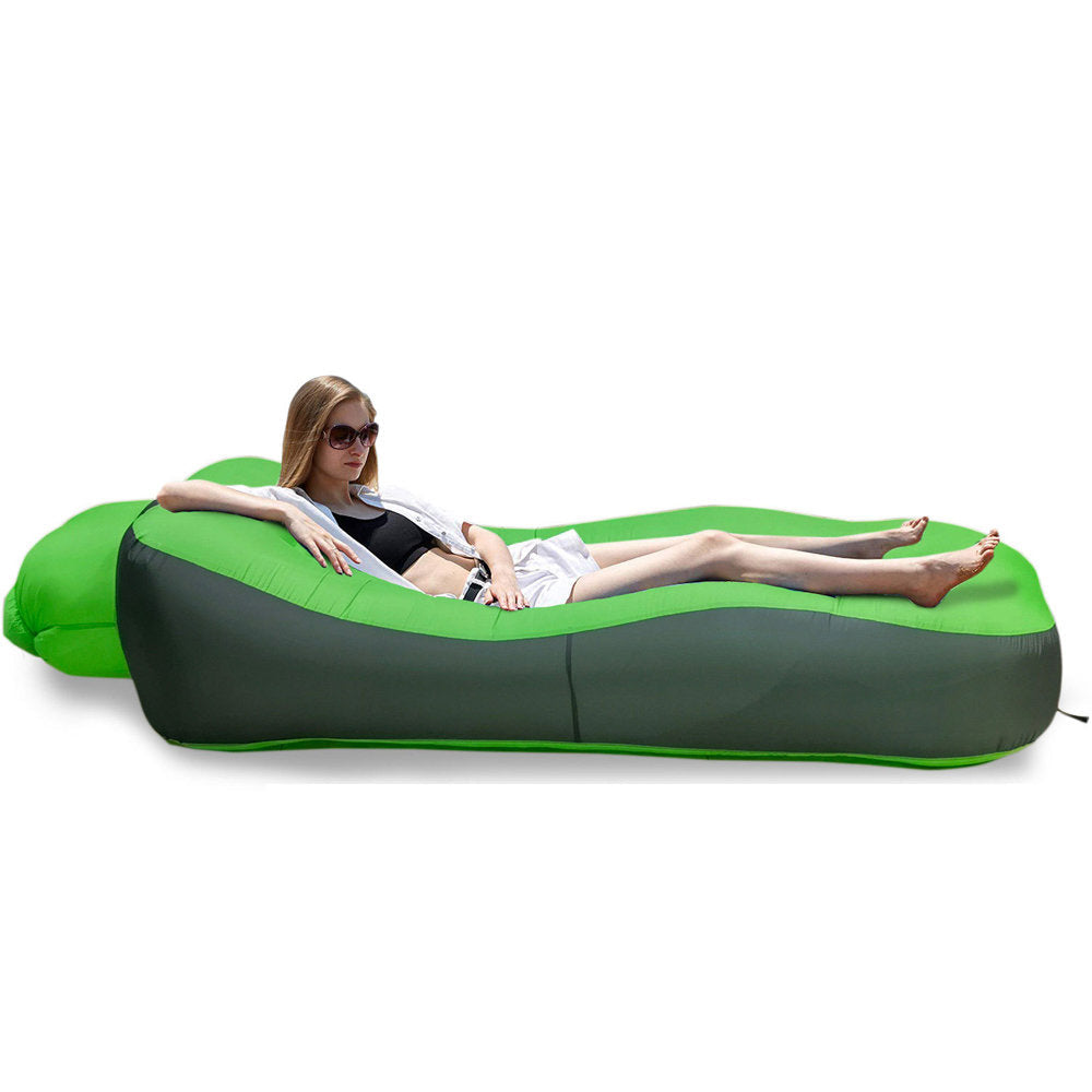 Inflatable Pool Float Sofa – Portable Swimming Pool & Beach Lounger A green and dark gray inflatable camping lounger with a woman reclining on it, shown on a white background with a small inset of the bag folded and dimensions labeled 19cm by 38cm. The brand name Otautau is visible in the top left.