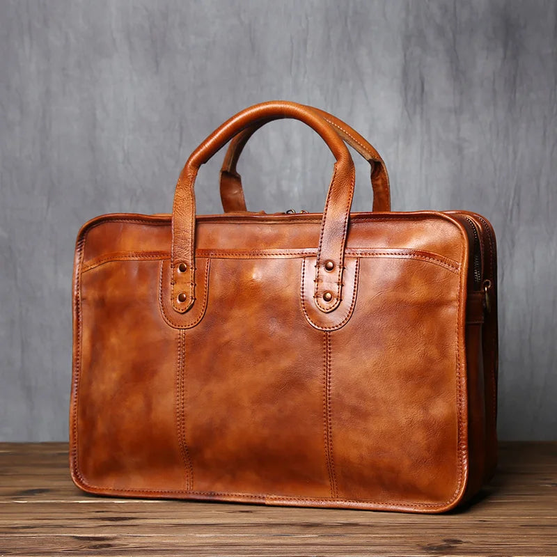 Genuine Leather Briefcase – Business Laptop & Travel Shoulder Bag Brown leather briefcase on a wooden surface with a gray background