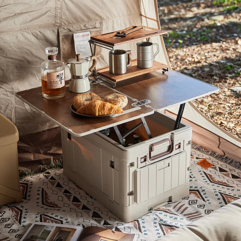 Folding Storage Box – Wooden Lid Camping & Trunk Organizer Portable outdoor kitchen setup with a table, coffee maker, and food items inside a tent.