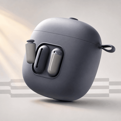 A dark gray wireless earbuds case with two earbuds partially visible, shown on a clean light beige studio background with soft warm light rays.