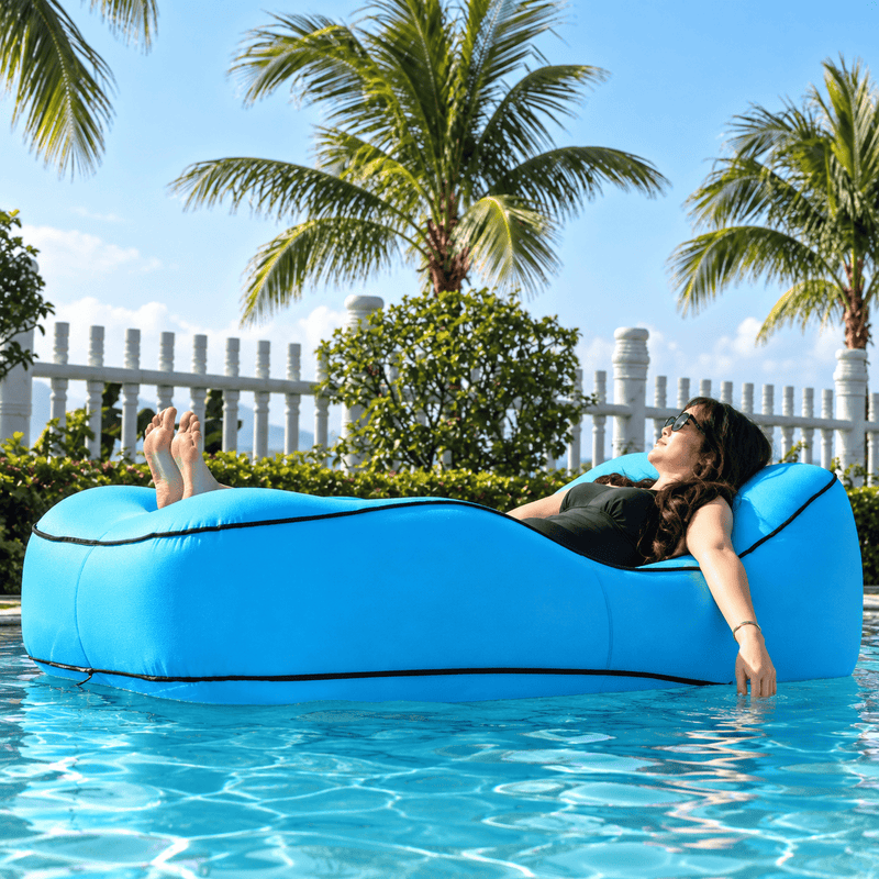 Blue inflatable lounge with leaf pattern, featuring a woman relaxing on it, with Otautau branding.