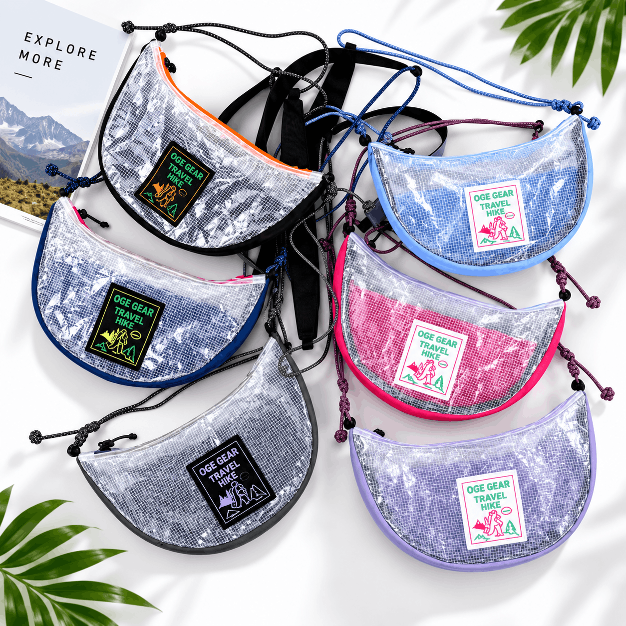Six small crescent-shaped pouches with a shiny sequin-like silver surface are arranged on a white background. Each pouch has a different trim color: orange, black, blue, purple, pink, and lavender, and a front patch reads 'OCE GEAR TRAVEL ADS'.