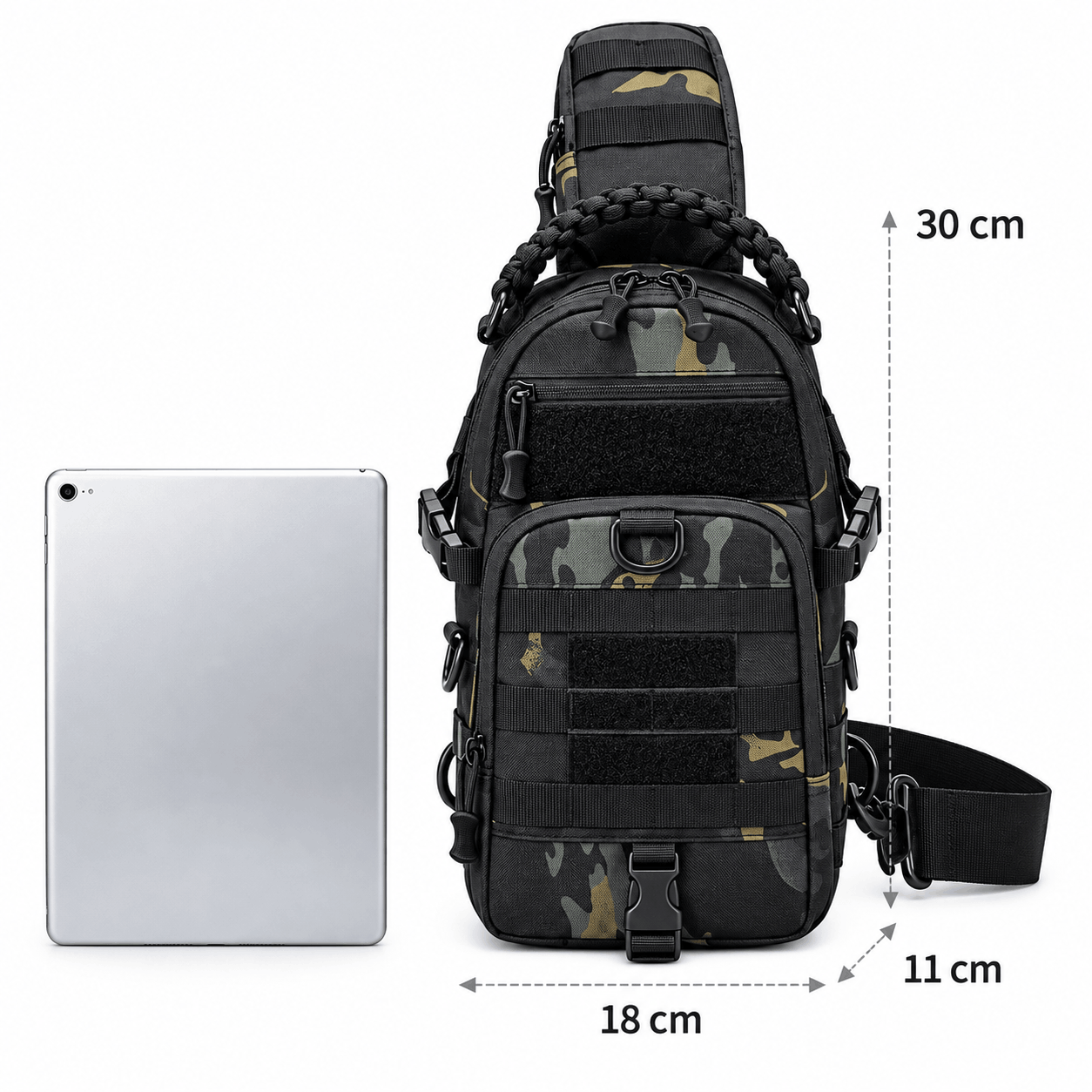 Black tactical sling backpack with camouflage accents, shown next to an iPad for scale with dimension markings of 18 cm width, 30 cm height, and 11 cm strap depth on a white background.