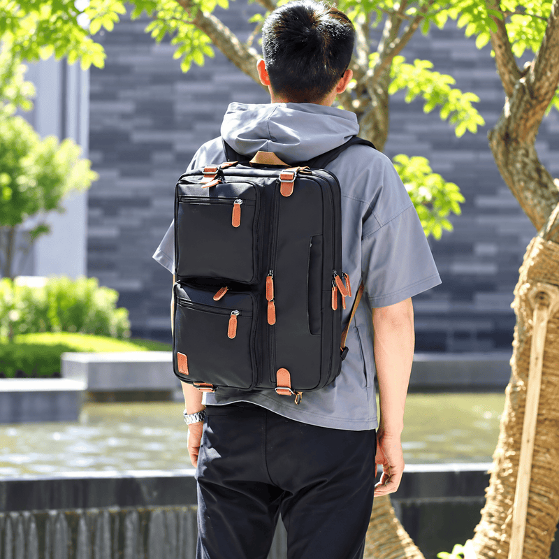 A navy blue nylon laptop bag with tan webbing handles and shoulder strap, featuring multiple zippered pockets. The image includes text overlays reading '15inch' and 'Material: NYLON' on a plain white background.
