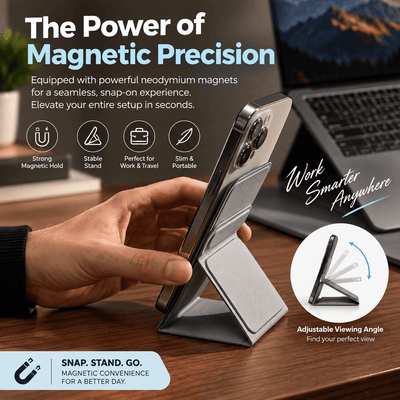 A hand holds a silver magnetic phone stand holding a smartphone, with promotional text and icons highlighting magnetic precision, stable stand function, slim portable design, and adjustable viewing angle on a desk with a blurred laptop background.