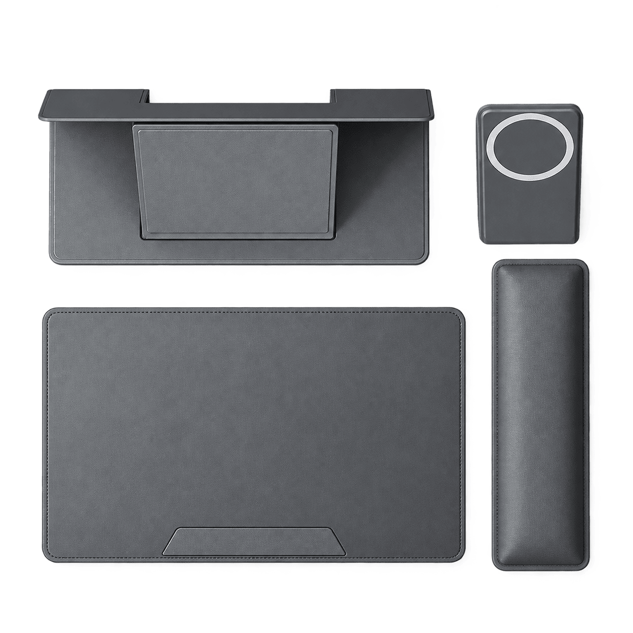 A dark gray multi-piece ergonomic desk pad set on a solid white background, including a desk mat with an integrated stand, a matching wrist rest, a rectangular mouse pad, and a small square pad with a circular cutout.