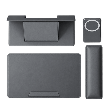 A dark gray multi-piece ergonomic desk pad set on a solid white background, including a desk mat with an integrated stand, a matching wrist rest, a rectangular mouse pad, and a small square pad with a circular cutout.