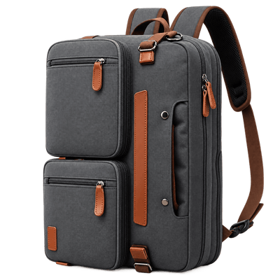 A dark gray canvas laptop backpack with brown leather accents, shown on a clean white background. The backpack features two front zippered compartments, a main zippered compartment, a vertical brown leather accent strip, and adjustable brown shoulder straps.