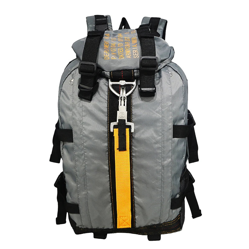 Gray backpack with black straps and a yellow zipper on a white background