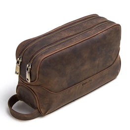 Brown leather toiletry bag with gold zipper on a white background