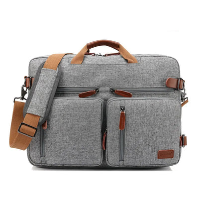 A gray nylon laptop bag with brown leather-look handles, zipper pulls, and strap accents, shown on a white background with text overlays reading '17inch' and 'Material: NYLON'.