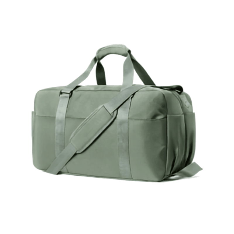 An off-white canvas duffel bag with brown straps and trim, shown from a three-quarter angle on a solid white background.
