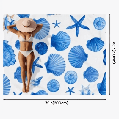 A beach-themed print featuring blue seashells and starfish on a white background, shown with dimension markers indicating 79 inches by 83 inches (200 cm by 210 cm). A woman in a white bikini and beige sun hat is printed on the surface.