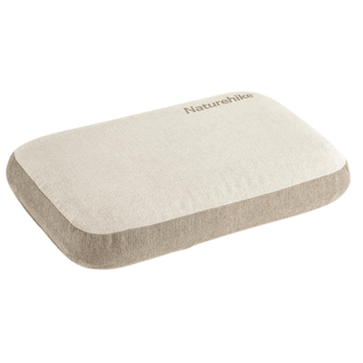 A rectangular Naturehike memory foam pillow in a light beige color, shown from a three-quarters perspective on a solid white background.