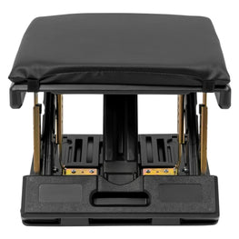 Black massage table with a cushion on a white background