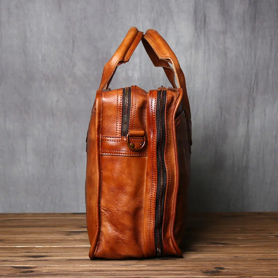 Brown leather bag with a zipper on a wooden surface and gray background