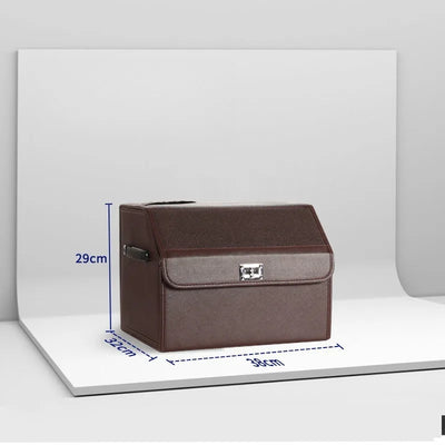 A brown faux-leather storage box with a front pocket and silver clasp, shown on a white display board with blue dimension lines indicating 29cm height, 32cm width, and 39cm depth.