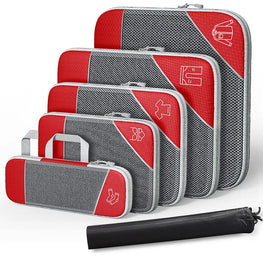 Set of red and gray packing cubes with a black compression bag on a white background