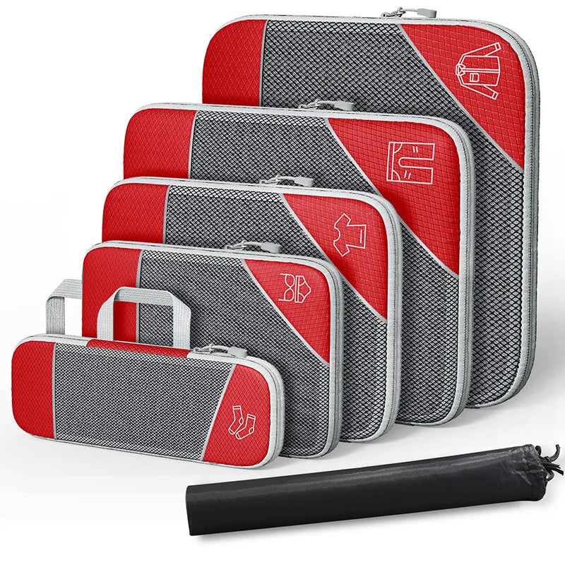 Set of gray and blue packing cubes with a black compression bag on a white background