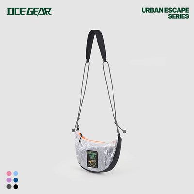 A semi-circular crossbody bag from Ice Gear, featuring a metallic silver patterned body, black trim, a black shoulder strap, and a small green brand patch on the front. The image is set against a light gray background with 'ICE GEAR' and 'URBAN ESCAPE SERIES' text, plus color swatches in the bottom-left corner.