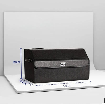 A black rectangular storage box or trunk with a front flap and small silver clasp, shown on a white display stand with blue dimension lines indicating 29 cm height, 32 cm width, and 53 cm depth.