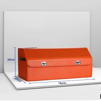 An orange storage trunk or briefcase-style box with silver metal latches, shown on a white display board with blue dimension lines indicating 35cm length, 29cm height, and 32cm width.