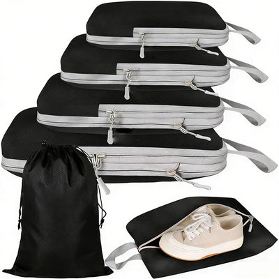 Set of black and gray packing cubes with a drawstring bag and shoe container on a white background