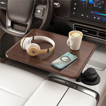 Wooden car tray with headphones, phone, and coffee cup inside a vehicle.