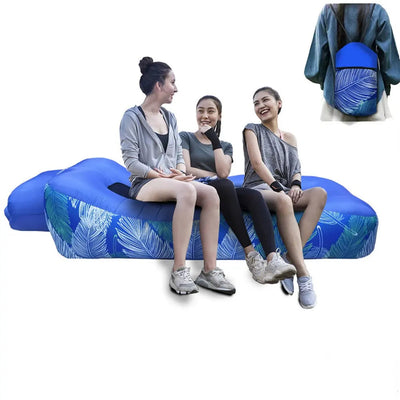Three women sitting on a blue inflatable sofa with a backpack in the corner, featuring the brand 'Otautau'.
