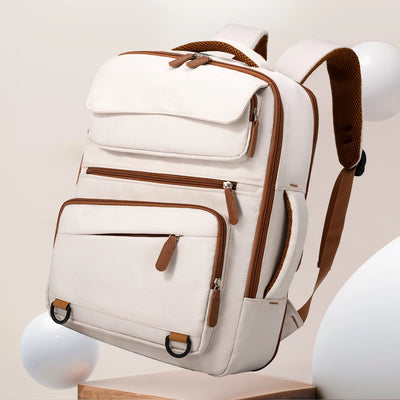 White backpack with brown accents on a neutral background