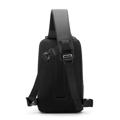 A black BANGE single-strap sling backpack shown from the back, featuring a textured mesh fabric body, a wide padded shoulder strap, and adjustable plastic buckle straps, set against a plain white background.