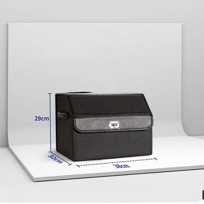 A black textured organizer box with a gray textured front band and silver metal clasp, shown on a white display board with blue dimension lines indicating 29cm height, 32cm width, and 39cm depth.