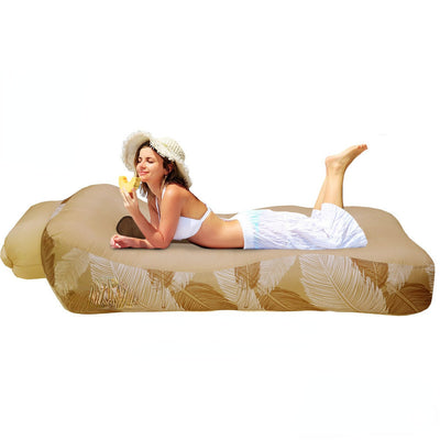 Woman lying on a portable inflatable bed with leaf pattern, Otautau brand visible.