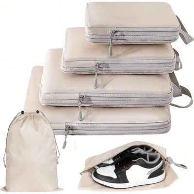 Set of beige and gray packing cubes with a shoe bag on a white background