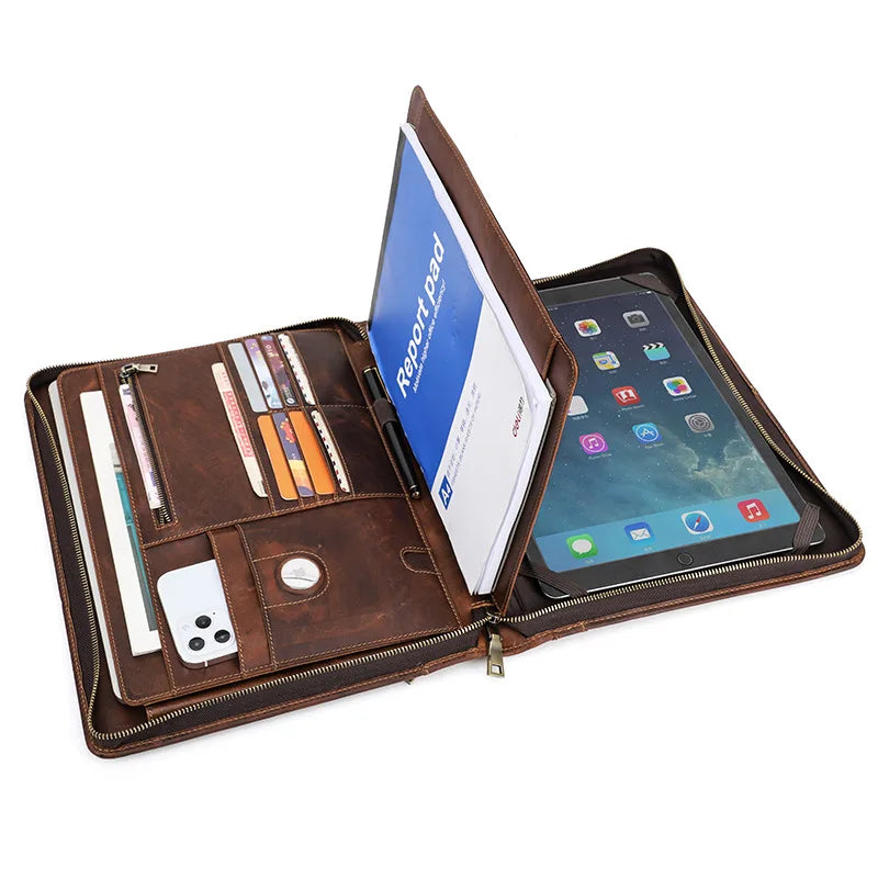 Brown leather organizer with tablet, phone, and stationery items on a white background
