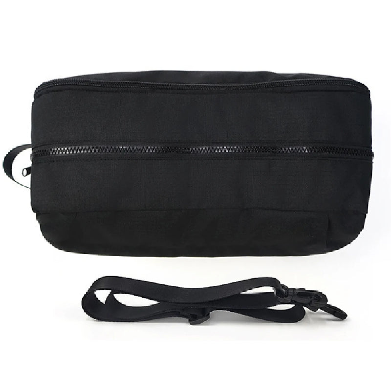 A black nylon crossbody bag with a zippered front pocket and an adjustable shoulder strap, shown on a white background with a small inset demonstrating the strap opening.