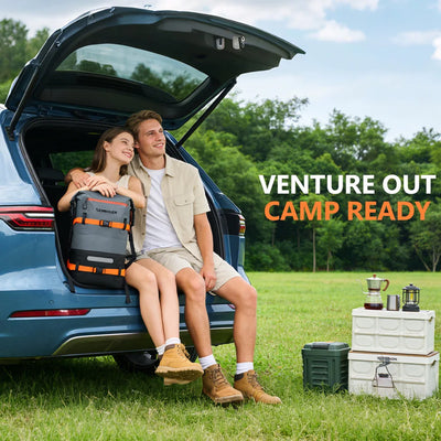 Couple sitting in a car with an open trunk, surrounded by nature, with camping gear and text 'Venture Out Camp Ready'.