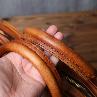 Brown leather wallet held by a hand with a wooden surface in the background