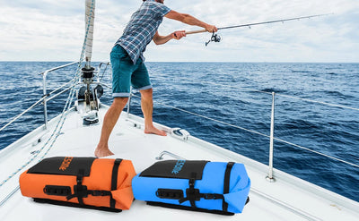 Person fishing on a sailboat with two life vests on the deck.