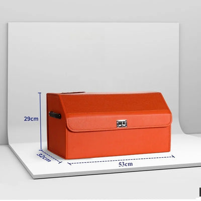 An orange textured leather storage box with a hinged lid and silver clasp, shown on a white display stand with blue dimension lines indicating 29cm height, 32cm width, and 53cm depth.