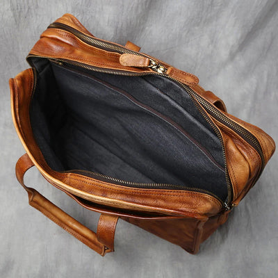 Brown leather bag with open front pocket on a gray background